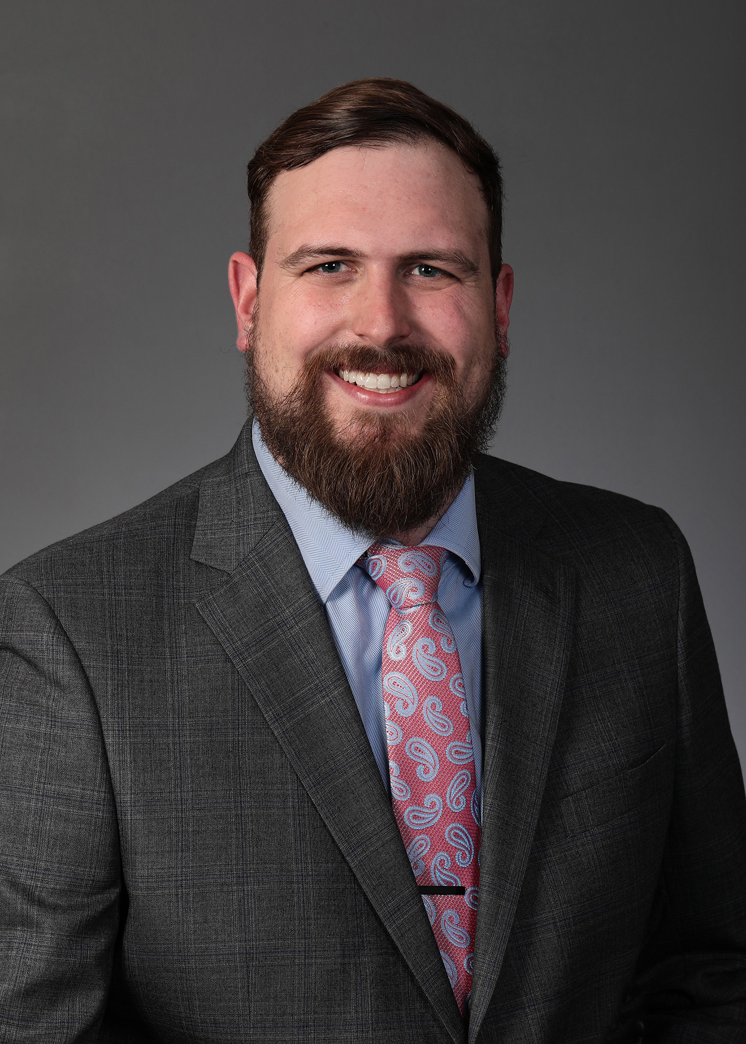 a man in a suit smiling