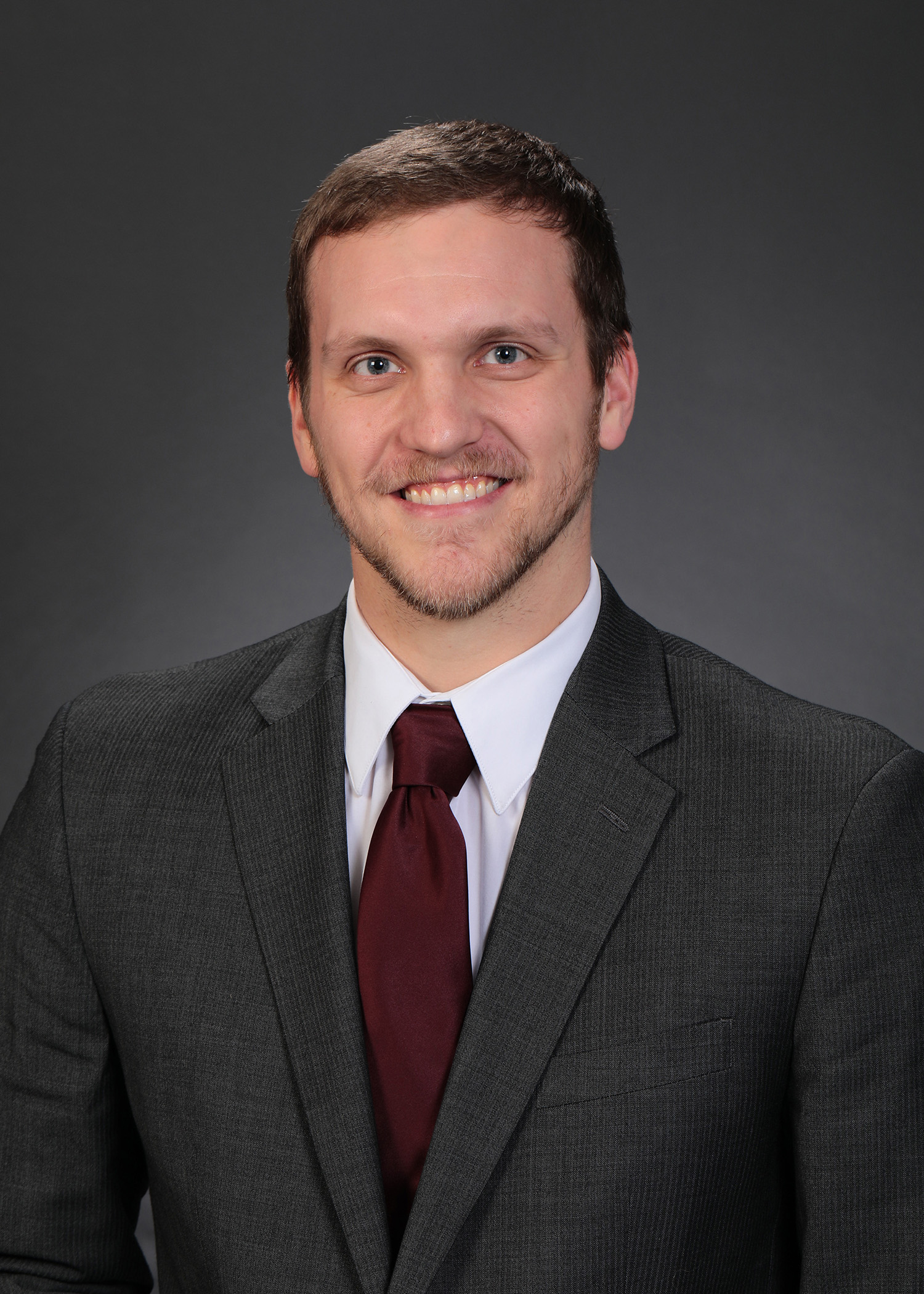 a man in a suit smiling
