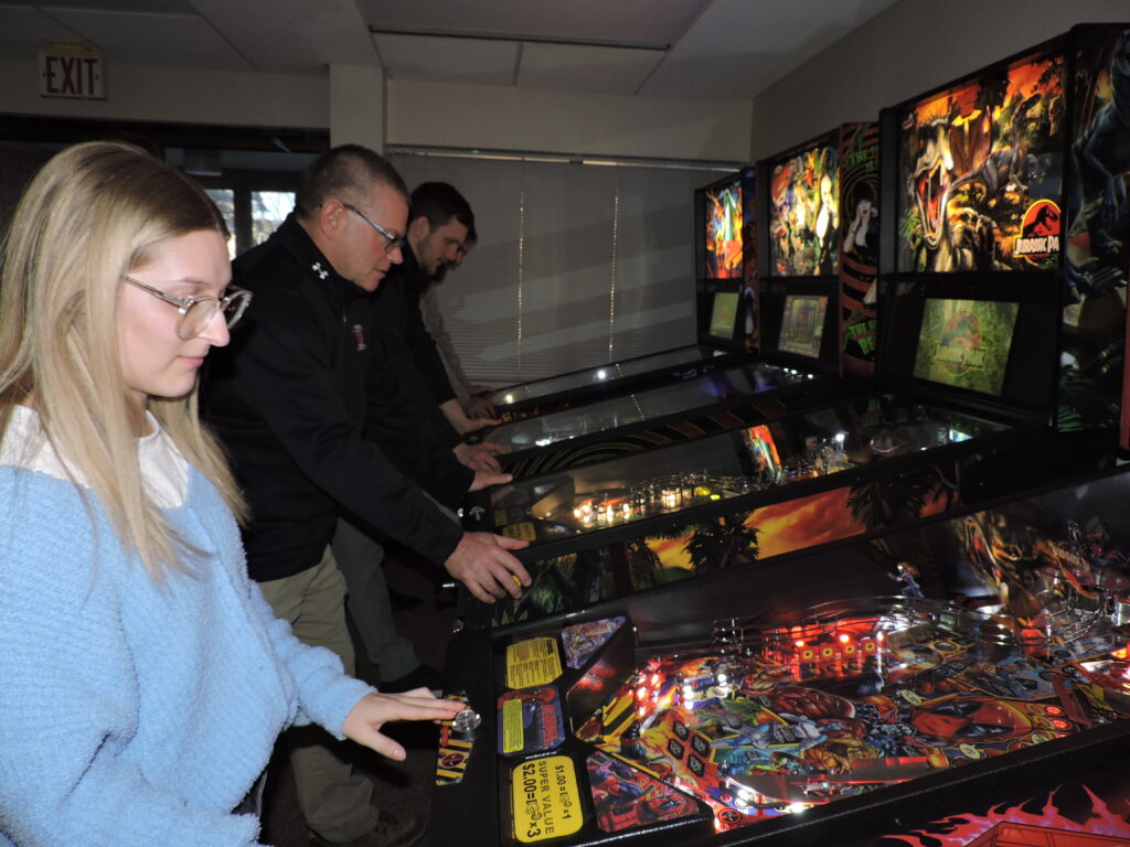 people playing pinball