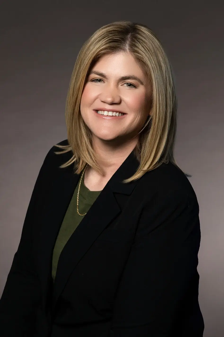 woman in suit smiling