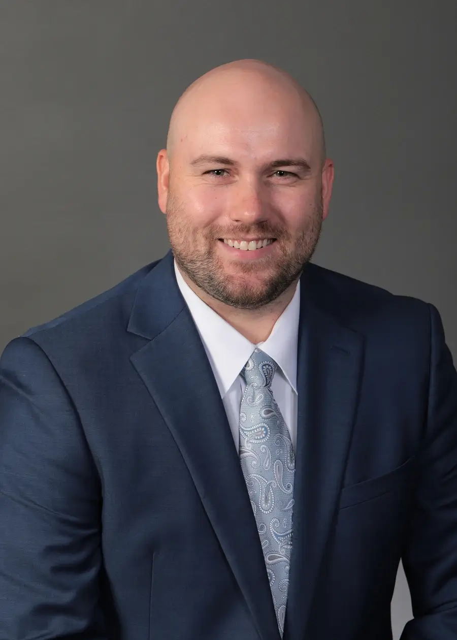 a man in a suit smiling