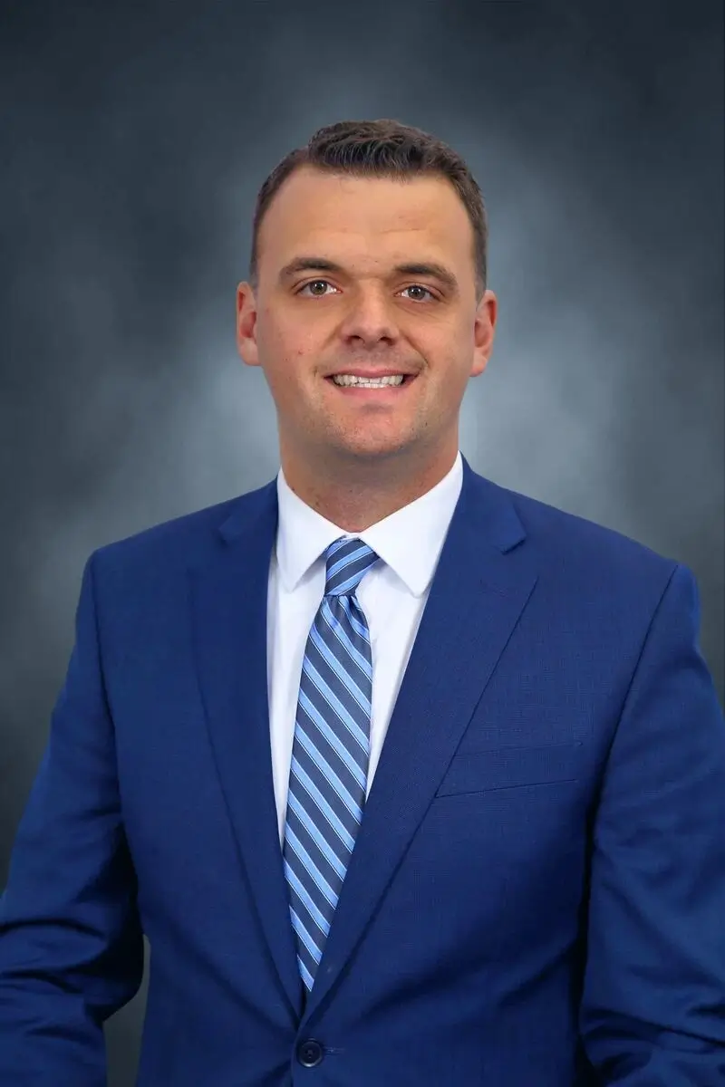 a man in a suit smiling