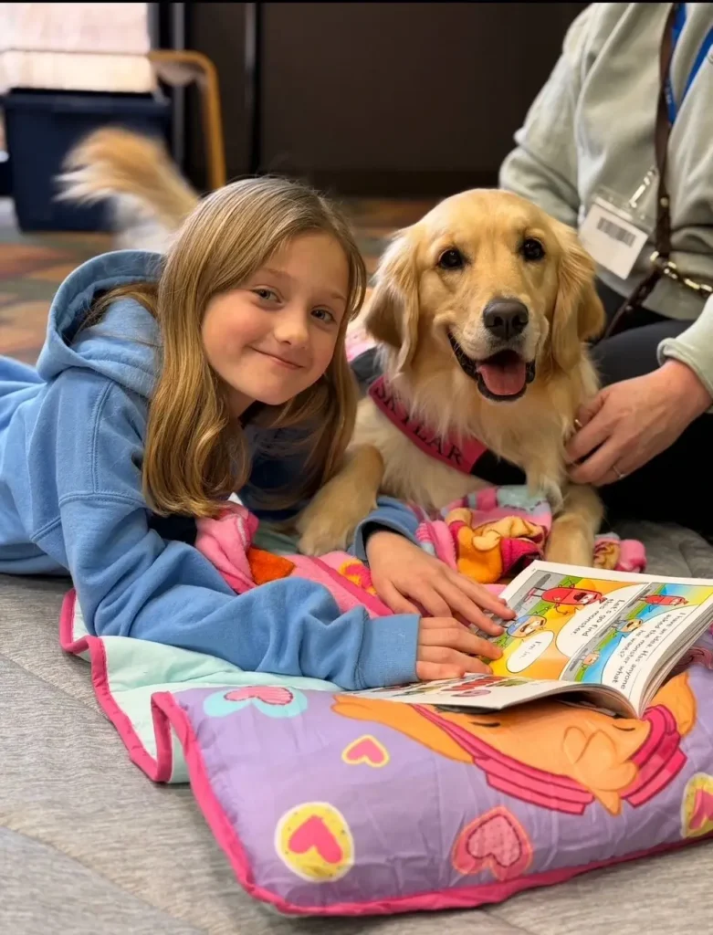 girl lying with a friendly dog in a cozy indoor setting